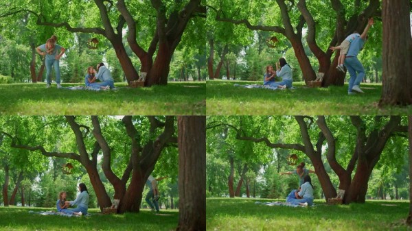 微笑的家人在大自然中享受乐趣。父母和孩子们一起野餐。