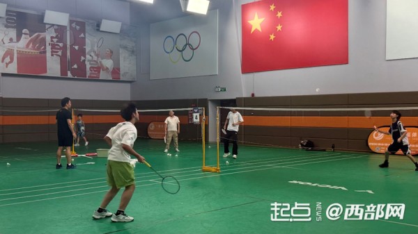 羽毛球馆内正在上私教课的学生