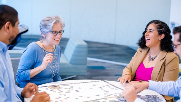 Group of employees playing a puzzle during a break