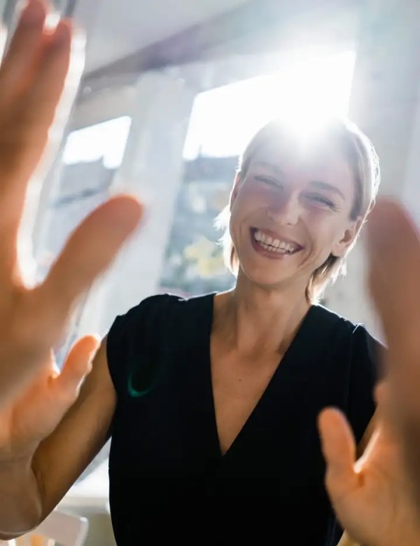 Female and male giving each other high five in an office