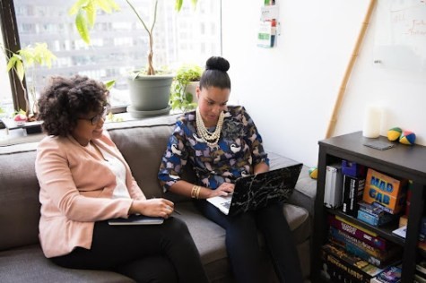 Two professionals discussing "What is Salesforce opportunity management?" and its role in helping businesses track and manage sales opportunities effectively