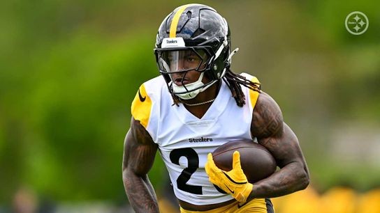 Steelers' rookie Kaleb Johnson carrying the football during mandatory mini camp.
