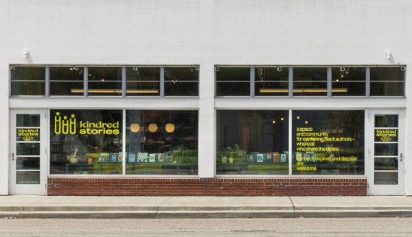 Exterior of a bookstore, with a sign reading "Kindred Stories."
