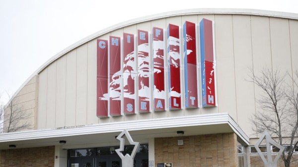 The front of Chief Sealth high school in Seattle, WA with the school's color and logo on the facade.