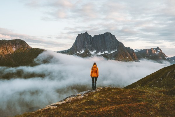Solo Travel Inspiration Woman Looking at Mountain Lanscape