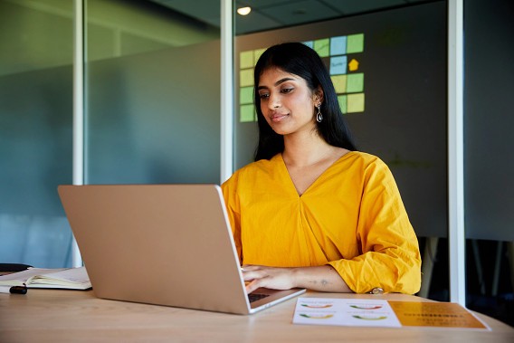 woman working on laptop in meeting room