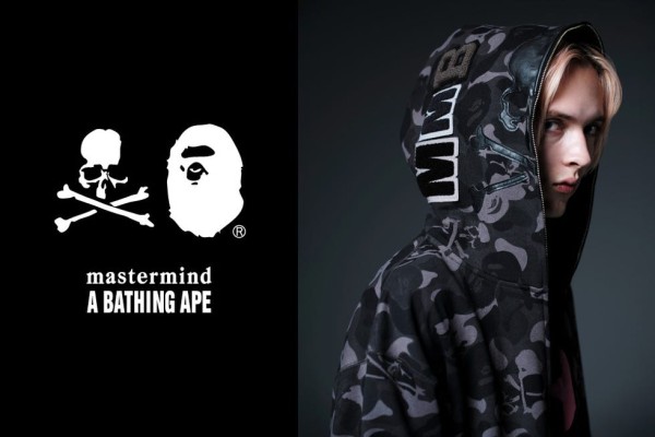 a fashion model showcasing a hooded sweatshirt featuring a camouflage pattern and various branding elements