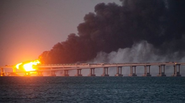 The Kerch Bridge in flames after being hit in October 2022. Pic: AP