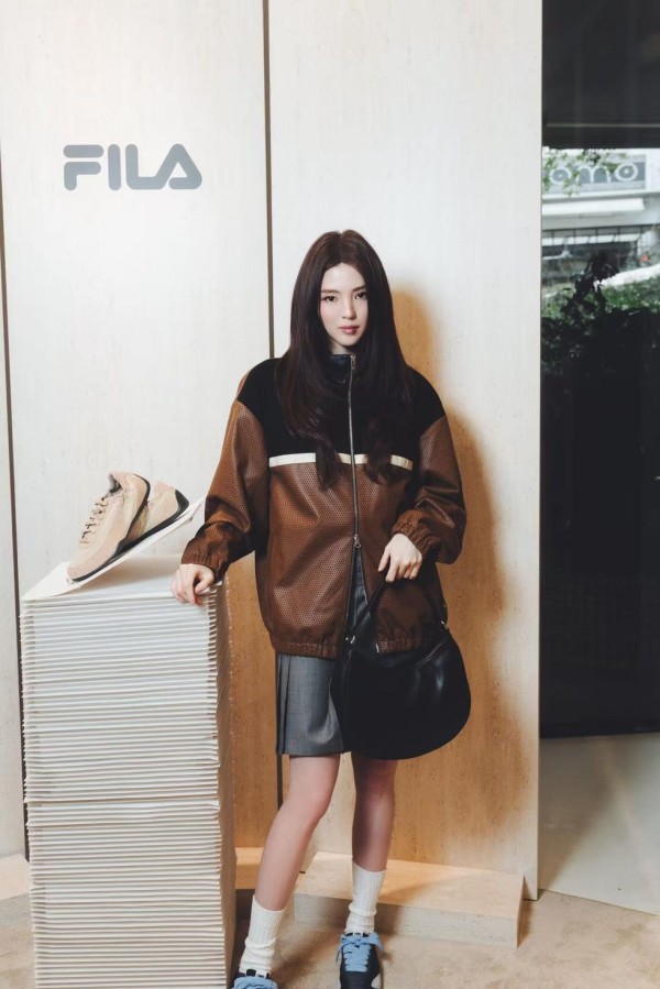 female model posing in a retail store display featuring sportswear