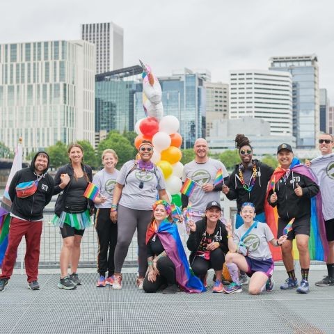 a group poses by the river