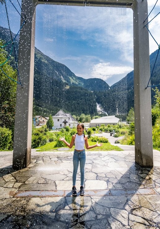Krimmler WasserWelten, Mädchen steht unter dem Wasserfallvorhang | © krimmler-wasserwelten.at/Michael Stabentheiner