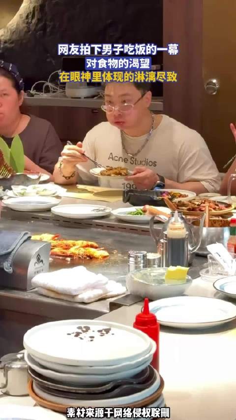 网友拍下男子吃饭的一幕，对食物的渴望，在眼神里体现的淋漓尽致